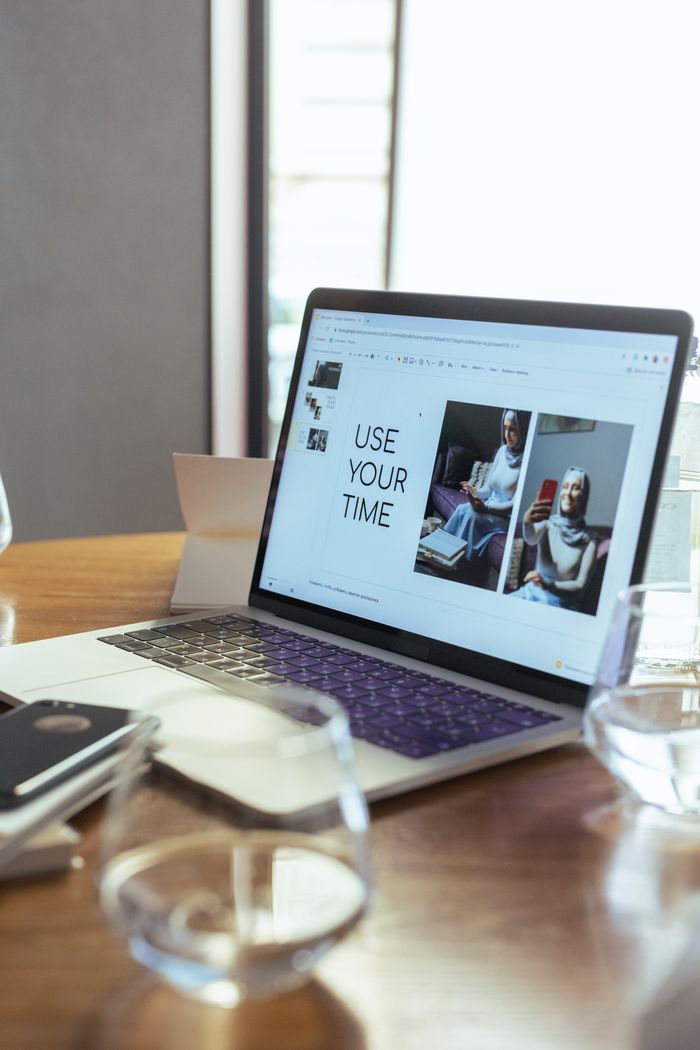 The Art of Drawing Readers In: Your attractive post title goes here A laptop displaying a productivity presentation in a modern workspace.